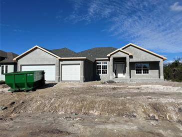 Newly constructed home with a two-car garage and stucco exterior at 13823 Allamanda Cir, Port Charlotte, FL 33981