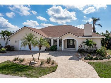 Beautiful one-story home with a tile roof, landscaping, and a paved driveway at 2813 Sancho Panza Ct, Punta Gorda, FL 33950