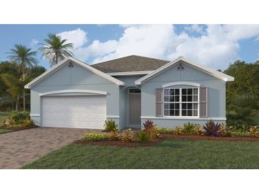 Single-story home with light blue exterior, white garage door, and landscaping at 9531 Turtle Grass Cir, Punta Gorda, FL 33950