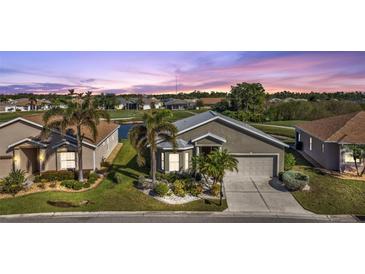 Aerial view of a house with a golf course and lake nearby at 24368 Westgate Blvd, Punta Gorda, FL 33980