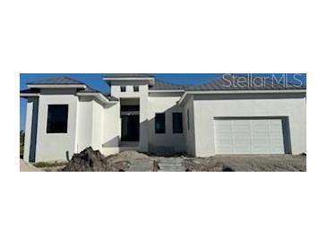 Modern two-story house with a metal roof and attached garage at 16380 Cape Horn Blvd, Punta Gorda, FL 33955