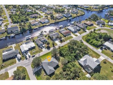 Beautiful aerial view showcasing a residential neighborhood with waterfront properties and serene canal access at 18514 Goodman Cir, Port Charlotte, FL 33948