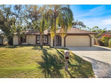Nice house with a two-car garage and a well-maintained lawn at 21047 Baffin Ave, Port Charlotte, FL 33954