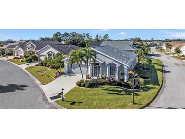 Attractive single-story home with landscaped yard and two-car garage in quiet community at 24415 Buckingham Way, Punta Gorda, FL 33980