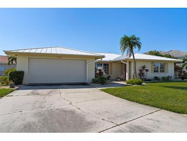 Single-story home exterior with attached garage and mature landscaping at 2501 Rio Largo Ct, Punta Gorda, FL 33950