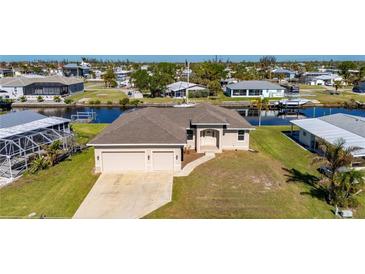 Aerial view of single-Gathering home with two-car garage and canal access at 740 Kingfish Ct, Punta Gorda, FL 33950