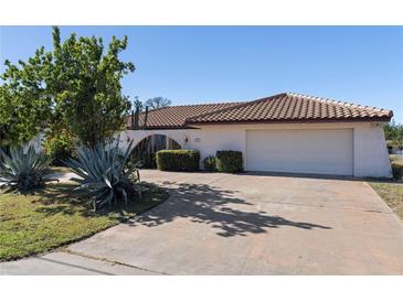 Single-story home with tile roof, attached garage, and landscaping at 3041 Clifford St, Punta Gorda, FL 33980