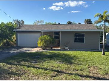 Newly renovated home with a large yard and attached garage at 4525 Church St, Punta Gorda, FL 33980