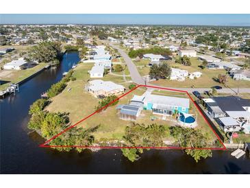 Aerial view of waterfront home with large lot and canal access at 103 Salem Ave Nw, Port Charlotte, FL 33952