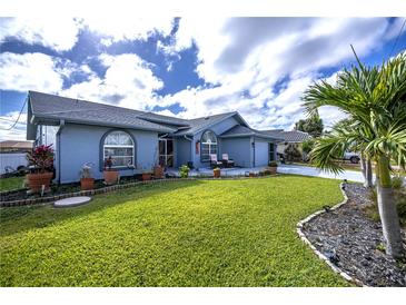 Charming single-story home with well-manicured lawn, attractive landscaping, and inviting curb appeal at 19983 Midway Blvd, Port Charlotte, FL 33948