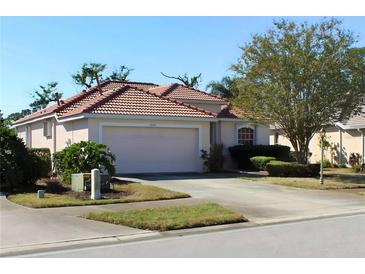 Charming one-story home with a tile roof, well-maintained landscaping, and a two-car garage at 3097 Royal Palm Dr, North Port, FL 34288