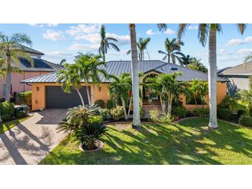 Attractive single-story home with lush landscaping and palm trees at 3225 Antigua Dr, Punta Gorda, FL 33950