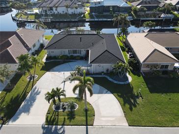 Aerial view of a single-Gathering home with a circular driveway and lush landscaping at 726 Macedonia Dr, Punta Gorda, FL 33950