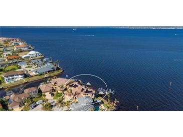 Stunning aerial view of a waterfront home with a private dock and solar panels at 2102 Palm Tree Dr, Punta Gorda, FL 33950