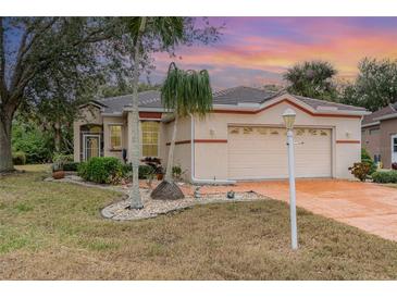 One-story home with attached garage and landscaped front yard at 10494 Princess Ct, Punta Gorda, FL 33955