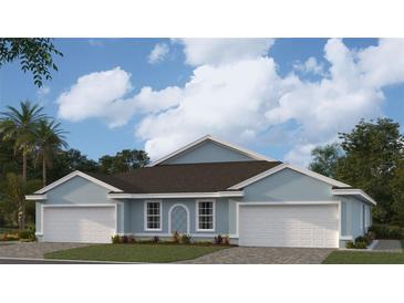 Two-car garage, light blue exterior, and a dark brown roof at 2051 Royal Tern Cir, Punta Gorda, FL 33983