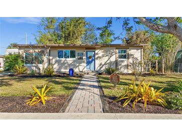 Updated bungalow exterior, landscaped yard, walkway to entrance at 4740 Bayano St, North Port, FL 34287