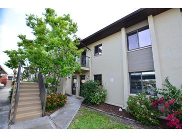 Well-maintained condo building with a walkway and landscaping at 4048 Oakview Dr # F2-4, Punta Gorda, FL 33980