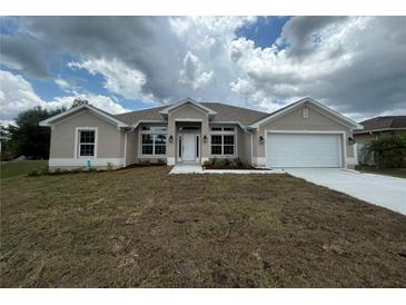 Charming single-story home featuring a manicured lawn, two-car garage, and beautifully coordinated exterior paint scheme at 507 San Ambrosio St, Punta Gorda, FL 33983