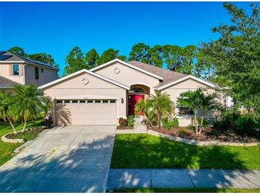 Attractive single-story house with a red door and well-manicured landscaping at 2507 Hobblebrush Dr, North Port, FL 34289