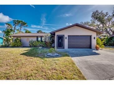 Front exterior view of a single-story home with a two-car garage at 3404 Depew Ave, Port Charlotte, FL 33952