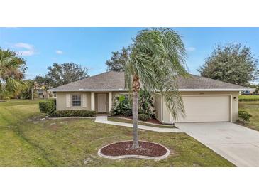 Charming single-story home with a landscaped front yard and attached two-car garage at 26090 Huanuco Dr, Punta Gorda, FL 33983