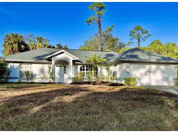 Single-story house with attached garage, landscaping, and a spacious front yard at 4435 Inverness St, North Port, FL 34288