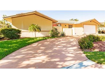 Single-story home with a circular driveway and mature landscaping at 69 Sabal Dr, Punta Gorda, FL 33950