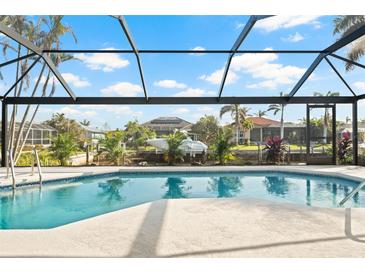 Beautiful pool area with screened enclosure and waterfront views, perfect for relaxation and entertaining at 210 Divinci Dr, Punta Gorda, FL 33950