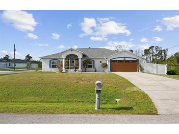 Single story home with a large front lawn and attached garage at 3343 Sorrel St, Port Charlotte, FL 33981