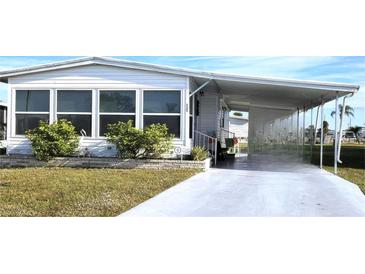 Charming single-story home with covered parking and well-maintained landscaping at 525 Parkwood Ave, North Port, FL 34287