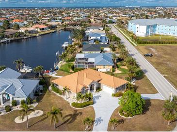 Aerial view of waterfront home with canal access and lush landscaping at 2100 Cassino Ct, Punta Gorda, FL 33950