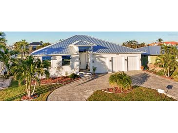 Beautiful single-Gathering home boasts a three-car garage and attractive landscaping at 2750 W Marion Ave, Punta Gorda, FL 33950