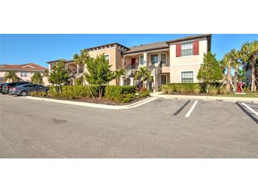 Exterior view of a two-story building with parking at 23343 Collina Way # 203, Punta Gorda, FL 33980