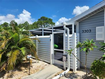 Charming home featuring a secure and private screened-in entry, offering both security and inviting curb appeal at 3300 Loveland Blvd # 3303, Punta Gorda, FL 33980