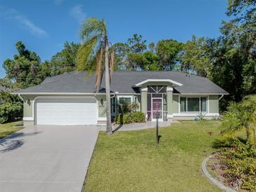 Charming single-story home featuring a well-manicured lawn and attached two-car garage at 3341 Briant St, North Port, FL 34287
