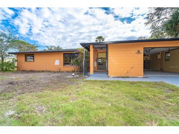 Quaint single-story home with unique architectural elements, and vibrant exterior paint at 201 Winson Ave, Englewood, FL 34223