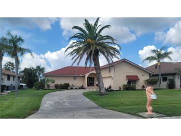 Charming single-story home with a well-manicured lawn and a unique seahorse-shaped mailbox at 674 Monaco Dr, Punta Gorda, FL 33950