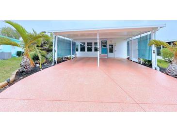 This covered carport boasts ample parking and a charming entrance to the home at 6642 Acacia Ct, North Port, FL 34287