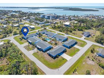 Aerial view of charming condos with a community pool and stunning ocean views in a desirable neighborhood at 1956 Wyoming Ave, Englewood, FL 34224