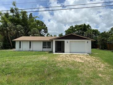 Charming single-story home with a one-car garage, surrounded by lush landscaping and a beautiful lawn at 432 Olivia Rd, Venice, FL 34293