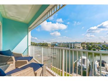 Balcony offers picturesque views of the canal and community, enhanced with comfortable seating for relaxation and enjoyment at 11723 1St E St, Treasure Island, FL 33706