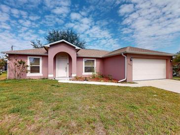 Charming single-story home with a well-maintained lawn and an attached two-car garage at 20370 Mount Prospect Ave, Port Charlotte, FL 33952