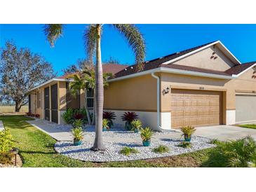 Charming single-Gathering home featuring a well-manicured lawn and a two-car garage at 8858 Tuscany Isles Dr, Punta Gorda, FL 33950