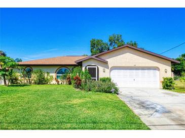 Charming one-story home with a well-manicured lawn and a two-car garage in a quiet neighborhood at 429 Dorchester St, Port Charlotte, FL 33954