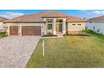 Stunning single-story home featuring a tile roof, paver driveway, and a two-car garage at 4320 Vasco St, Punta Gorda, FL 33950