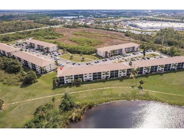 Expansive aerial shot of the condos showing green space, parking and lake views at 175 Kings Hwy # 538, Punta Gorda, FL 33983