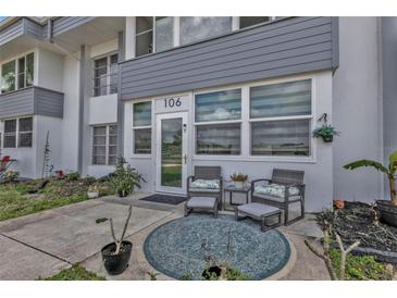 Inviting front porch with seating area, plants, and stylish decor for relaxing outdoor enjoyment at 21287 Gertrude Ave # 106, Port Charlotte, FL 33952