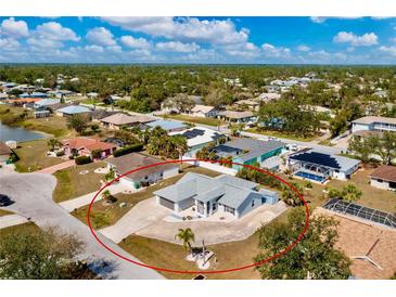 Wide aerial view of a light-colored single-story home showcasing a spacious lot and neighborhood at 21332 Walling Ct, Port Charlotte, FL 33954