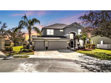 Well-maintained two story home featuring a three car garage, landscaped yard, and beautiful curb appeal at 24528 Sunrise Dr, Punta Gorda, FL 33980